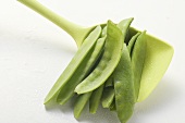 Blanched mangetout on cooking spoon