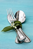Cutlery wrapped in ramsons (wild garlic) with scilla flower