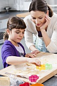 Mother and daughter baking biscuits