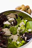 Salad leaves with goat's cheese and stuffed olives