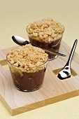Chocolate cream with bananas and crumble in two glasses