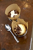Chocolate and vanilla cupcakes in tins with baking parchment