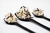 Wild rice and basmati rice on three wooden spoons