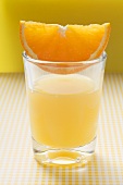 Orange juice with wedge of orange