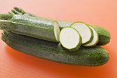 Courgettes on orange background