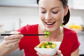 Woman eating Asian vegetables