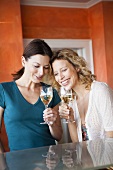 Two women drinking white wine