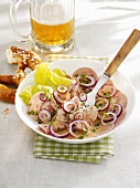Sausage salad with pretzel and beer (Bavaria)