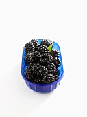 Fresh blackberries in blue plastic container