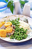 Pork chop with apricots, peas and rice