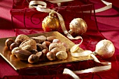 Different nuts on a golden plate with Christmas decorations