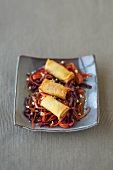 Spring rolls with mince filling on carrot and cabbage salad