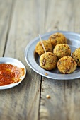 Deep-fried millet balls with tomato sauce