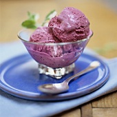 Blueberry ice cream in glass bowl