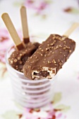 Ice creams on sticks with chocolate nut coating