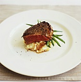 Beef steak on mashed potato with green beans