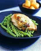 Chicken breast on beans and peas