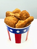 Breaded chicken pieces in paper cup with US colours