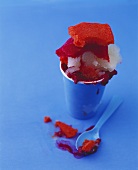 Sorbet in a paper cup against a blue background