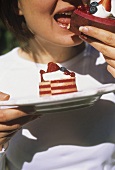 Woman eating a piece of fruit torte