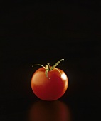 Tomato against black background