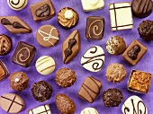 Assorted chocolates on purple background