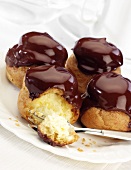 Four profiteroles with chocolate sauce