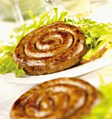 Cumberland sausages (English coiled sausages) with salad