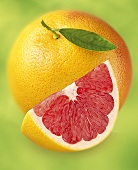 Grapefruit and wedge of grapefruit with pink flesh