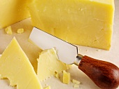 Cheese knife in a piece of Cheddar cheese