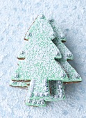 Christmas tree biscuits in icing sugar snow