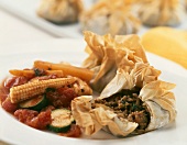 Filo pastry parcels filled with minced lamb, vegetable sauce