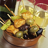 Tapas: chicken and olives on cocktail sticks