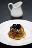 Ginger pudding with blackberries (turned-out)