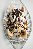 Banana split with vanilla ice cream, cream & grated chocolate