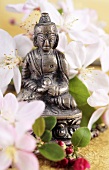 Buddha figure with white flowers