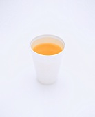 Orange juice in white beaker