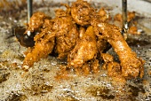 Deep-frying chicken pieces