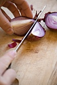 Cutting a red onion into quarters