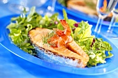 Fried salmon steak with mixed salad leaves and shrimps