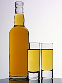 Brown rum in two glasses and a bottle