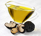 Truffle oil in a small jug, summer truffles in front