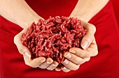 Hands holding fresh mince