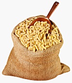 Macaroni in jute sack with scoop
