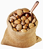 Assorted nuts in jute sack with scoop