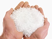 Hands holding coarse sea salt