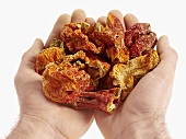 Hands holding dried red peppers