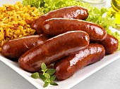 Fried chorizo sausages with rice and green salad