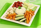 Raw vegetables on a platter with herb dip