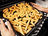 Man taking chips out of the oven